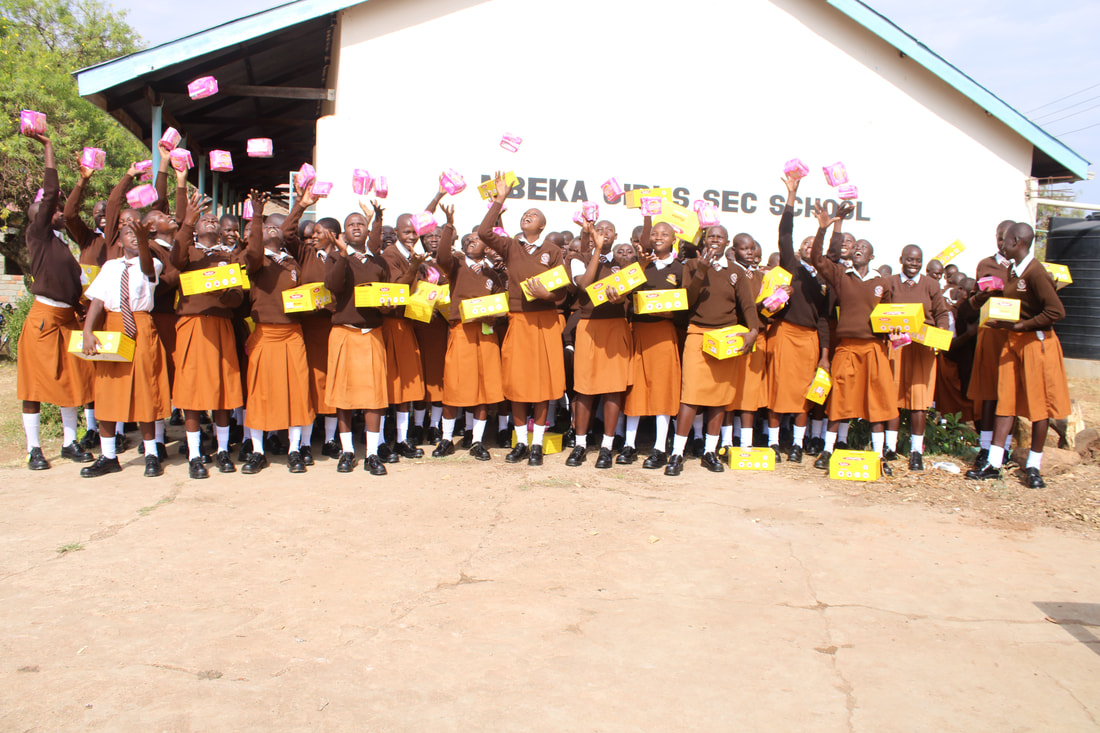 Students receiving shoes and sanitary pads