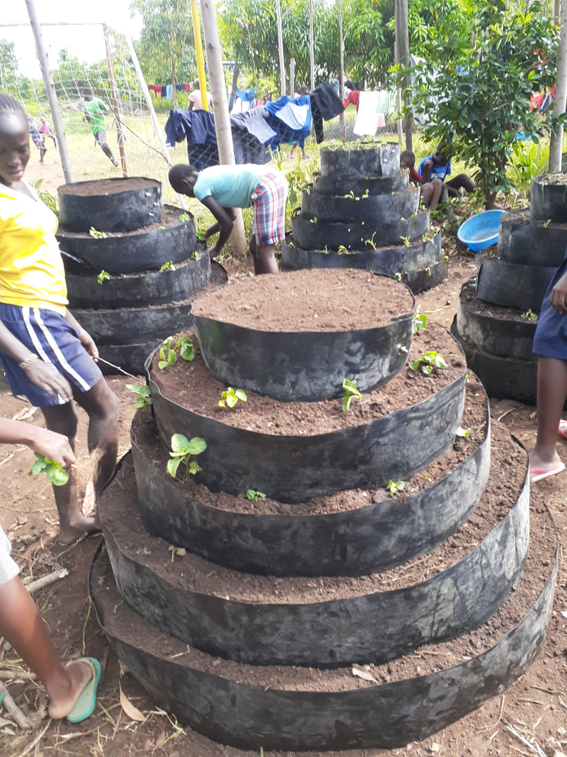 Students, mostly girls, preparing a conical garden